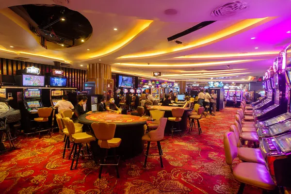 BLITZ App — Enjoy seamless gaming on your smartphone A young woman relaxing with her phone while dynamic casino elements float around her, illustrating the smooth mobile experience offered by the BLITZ app.