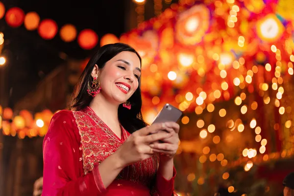 A stylish woman beside vibrant slot machines displaying glowing sevens, showcasing the variety of top slots at BLITZ.