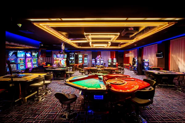 A player using their smartphone during a festive local event, representing BLITZ’s fully mobile-friendly casino.